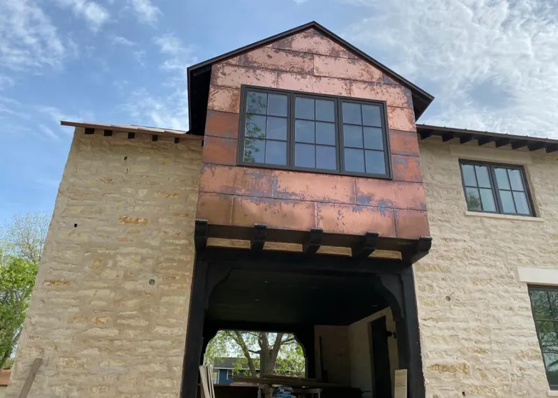 Copper metal panel facade on a stone building for Roof Repair in Lanett