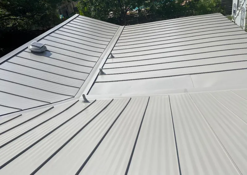 Solar attic fan installed on a metal roof for Roof Ventilation in Lanett